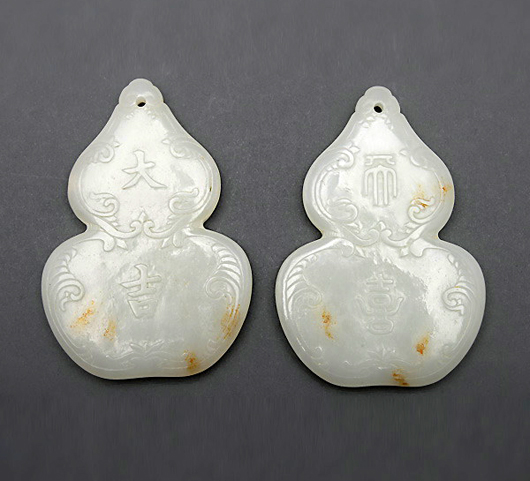 Two jade double gourd-form pendants. Sold for $106,200. Michaan’s Auctions image