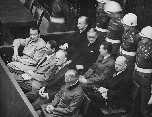 Nazi defendants seated in the dock during the Nuremberg Trials include Hermann Göring (first row, far left), considered to be the most important surviving official in the Third Reich after Hitler's death. Image courtesy of Wikimedia Commons.