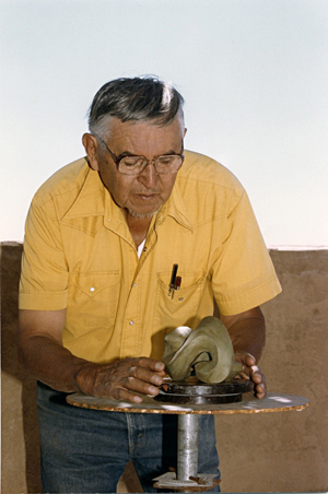 Allan Houser (1914-1994) working on the clay maquette for 'Abstract Infinity' in 1985. Copyright Anna Marie Houser, Allan Houser Inc. This work is licensed under the Creative Commons Attribution 3.0 License.