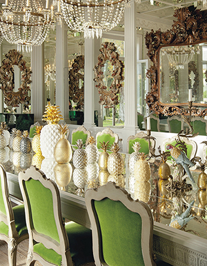 The formal dining room at the chateâu, including: a set of 20 Louis XV-style silver-painted dining chairs covered in green mohair Lelievre velvet (estimate: £8,000- £12,000) and a collection of 21 pineapple ornaments, late 20th century (estimate: £800-£1,200). © Christie’s Images Limited 2014.