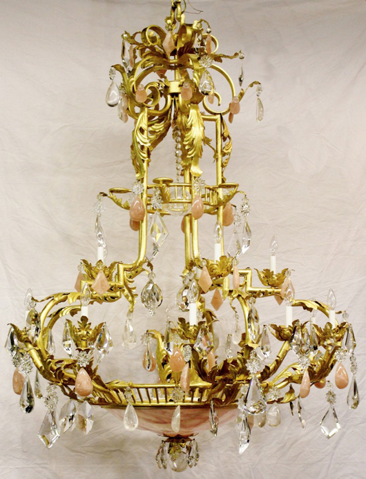 Impressive gilt metal chandelier with leaved motif with cut and faceted crystal prisms. Ahlers & Ogletree image.