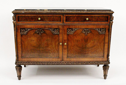 Beautiful marble-top mahogany sideboard with carved figural and scrolled foliate decoration. Ahlers & Ogletree image.