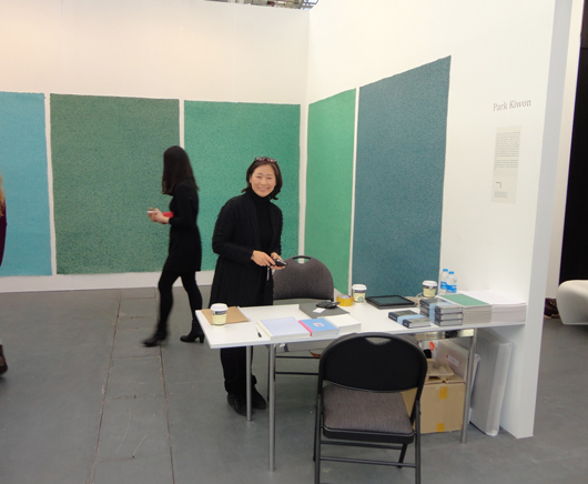 Hye Won Keum, director of SoSo Gallery of South Korea, with beautiful paintings on paper by Korean artist Park Kiwon at ART14 London. It was Keum’s second year at the fair. Image Auction Central News.