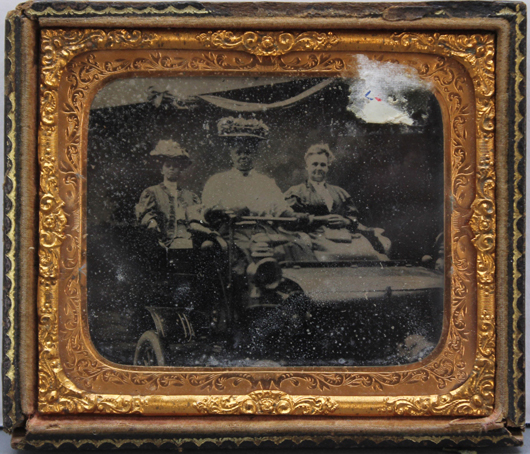 Circa-1901 ambrotype depicting three women in an open roadster with visible side lanterns and white rubber tires. Est. 100-$150. Waverly Rare Books image.