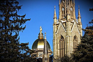 The distinctive feature known as the Golden Globe tops the University of Notre Dame's Main Building (left). At forefront is the university's Basilica of the Sacred Heart. Photo by Michael Fernandes, licensed under the Creative Commons Attribution-Share Alike 3.0 Unported license.