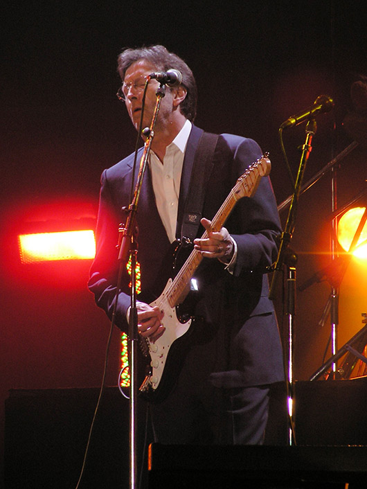 Eric Clapton plays his signature model Fender Stratocaster at the Tsunami Relief concert, Jan. 22, 2005. Image by Yummifruitbat. This file is licensed under the Creative Commons Attribution-Share Alike 2.0 Generic license.