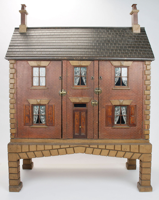 English Baby House, early to mid 1800s, featuring double chimneys with capped pots, scrolled arches under side eaves, shutters and beveled lintels. Est. $8,000-$12,000.