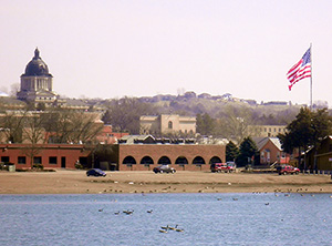 Pierre, S.D., with the state Capitol on the distant left and the Missouri River in the foreground. Image by Alanscottwalker. This file is licensed under the Creative Commons Attribution-Share Alike 3.0 Unported license.