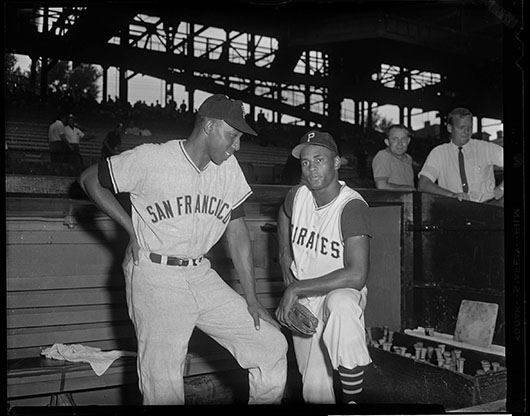 Charles ‘Teenie’ Harris; San Francisco Giants baseball player Willie McCovey with Pittsburgh Pirates player Roberto Clemente at Forbes Field, circa 1960; Heinz Family Fund, 2001.35.6560 © 2006 Charles ‘Teenie’ Harris Archive, Carnegie Museum of Art, Pittsburgh.