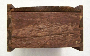 Riven wood can be identified by the rough tear marks along the grain pattern.