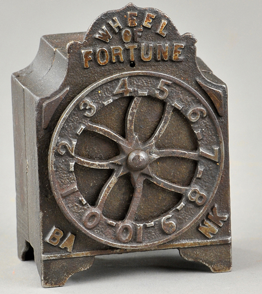 Wheel of Fortune bank, cast iron with japanned-type finish, est. $2,000-$3,000. Bertoia Auctions image