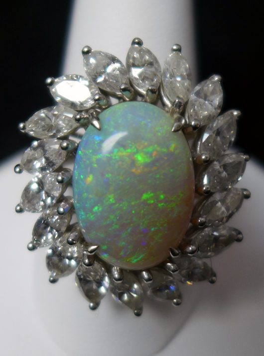 14K white gold cocktail ring with large opal and 18 marquise-cut diamonds. Sterling Auctions image