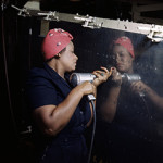 A real-life Rosie the Riveter operating a hand drill at Vultee-Nashville, Tenn., working on an A-31 Vengeance dive bomber in 1943. Image by Alfred T. Palmer, U.S. Office of War Information, courtesy of Wikimedia Commons.