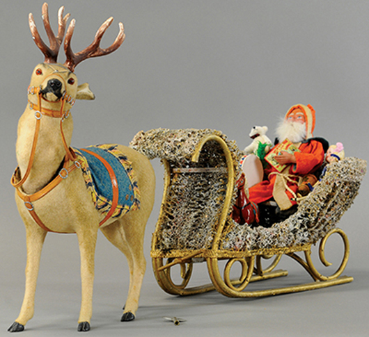 Clockwork reindeer nodder with Santa on sleigh, 30in overall length, sold for $11,210. Bertoia Auctions image