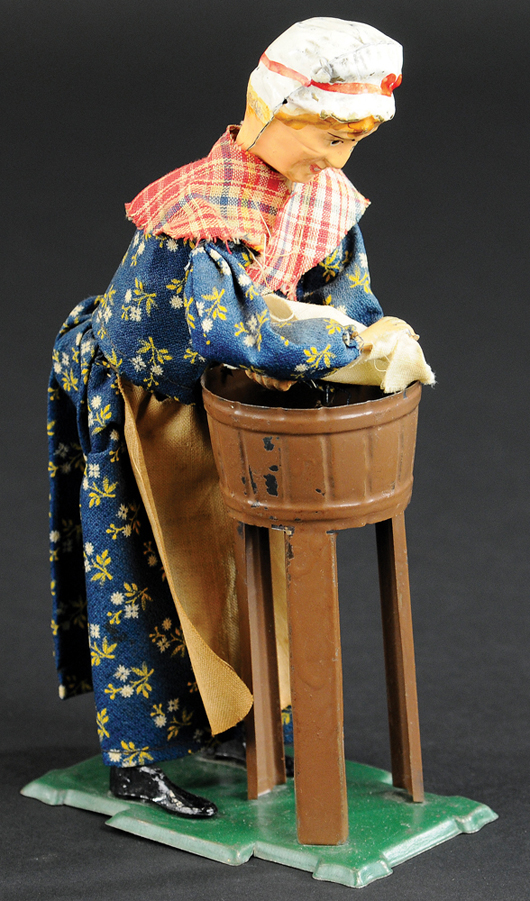 Fernand Martin Washer Woman clockwork toy, painted tin, cloth dressed, sold for $6,490. Bertoia Auctions image