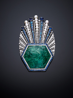 Aigrette, France, Paris, designed by Paul Iribe, made by Robert Linzeler, 1910. Platinum, set with emerald, sapphires, diamonds, and pearls. H. 3 5/8 in. (9 cm), W. 2 1/4 in. (5.6 cm), D. 5/8 in. (1.5 cm) Al-Thani Collection. Image courtesy Metropolitan Museum of Art.