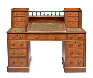 This English William IV desk cost only $984 at a New Orleans Auction Galleries sale. That's much less than a new desk of the same quality. The antique desk, made of solid mahogany in about 1830, has two shelves and 15 drawers.