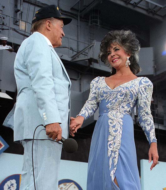 Elizabeth Taylor with Bob Hope at a USO show in 1986. Image courtesy of Wikimedia Commons.