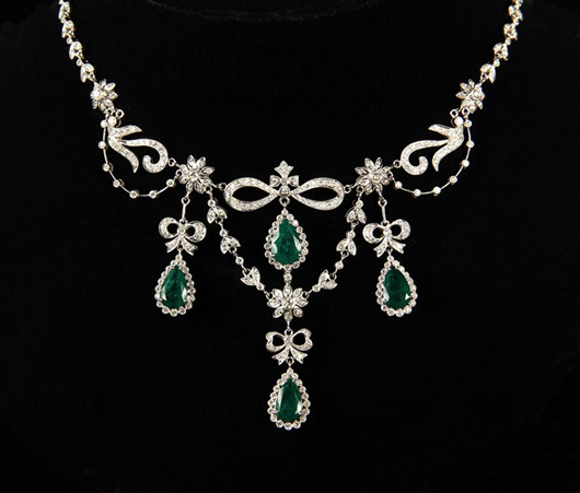 Eighteen-karat white gold necklace featuring four pear-shape emeralds suspended from diamond set ribbon forms. Estimate: $20,000-25,000. Thomaston Place Auction Galleries image.