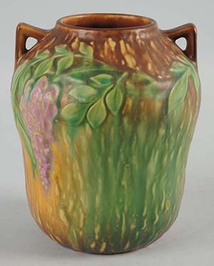 Roseville Wisteria pottery vase, 7in tall, retains original paper label. Est. $300-$500. Morphy Auctions image    