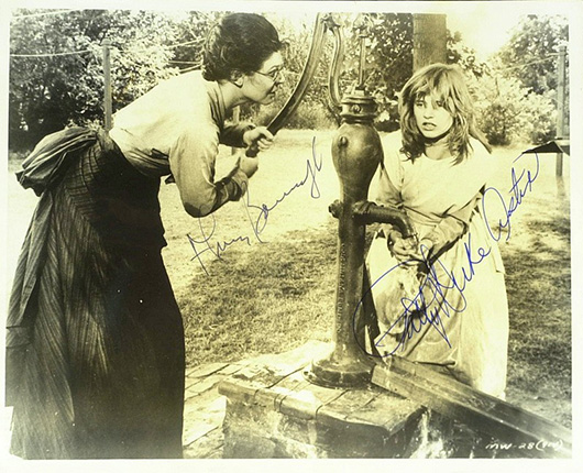 Anne Bancroft (1931-2005) and Patty Duke (1946- ) both autographed this 8-by-10 sepia tone photograph, a movie still from their 1962 film 'The Miracle Worker.' Image courtesy of LiveAuctioneers.com and The Written Word Autographs.
