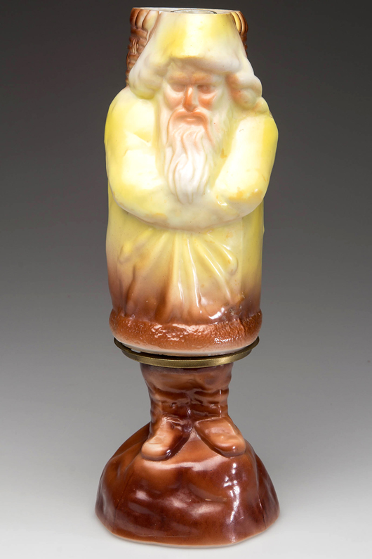 Santa figural miniature lamp, rare yellow and brown coloration. Estimate: $3,000-$5,000. Jeffrey S. Evans & Associates images.