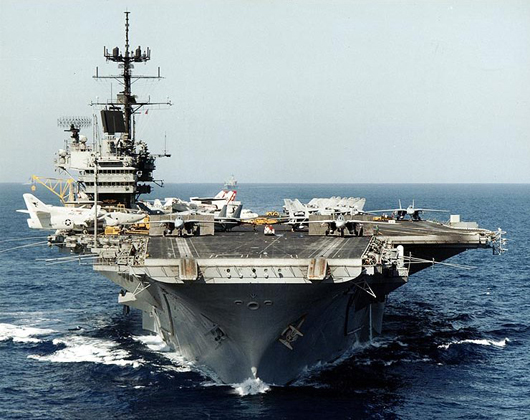 The USS Saratoga (CV-60) underway with F-14 fighters on her bow during operations in the Mediterranean Sea in September 1985. Naval Historical Center image, courtesy of Wikimedia Commons.