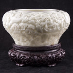 Lustrous white jade brush washer with Qianlong seal mark on a zitan stand, 10 inches diameter. Estimate: $30,000-$45,000. Linwoods Auctions image.