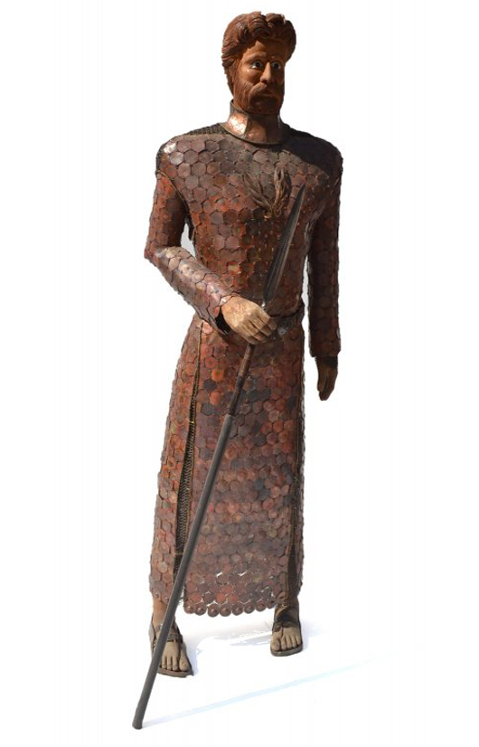 Larger than life mixed media sculpture of a knight wearing chain mail and a copper garment and holding lance. Roland Auctions image.