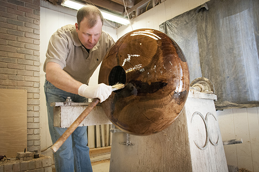Matt Moulthrop applies finish to the 'Auburn Oak' bowl. Image courtesy of Jule Collins Smith Museum of Fine Art, Auburn University.