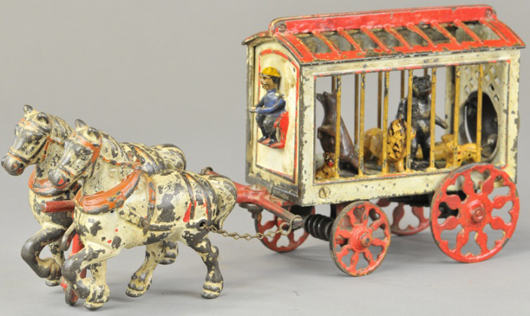Kyser & Rex cast-iron horse-drawn circus cage with animal figures, sold for $6,490. Bertoia Auctions image