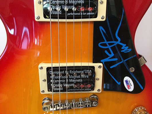 Rock ’n’ roll memorabilia items will include this vintage guitar signed by Peter Townsend of The Who. Tim’s Inc. Auctions image.