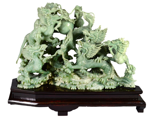 Outstanding carved jade group, Chinese, 20th century, the pale green stone carved with nine realistic dragons chasing the flaming pearl above the clouds, height 31inches, width 48 inches, depth 23 1/2 inches. Auction Gallery of the Palm Beaches Inc. image. 