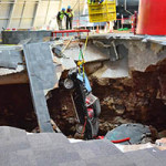 A crane is used to remove a 1962 Chevrolet Corvette from the sinkhole at the National Corvette Museum on March 4. It's the third to be extracted from the hole, which opened Feb. 12. Photo by National Corvette Museum for Chevrolet.
