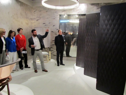 Michael Noah, chief designer at Linley, shows visitors a unique four- fold screen on the company’s stand at Masterpiece London. Price in the region  of £100,000 ($170,365). Image Auction Central News.