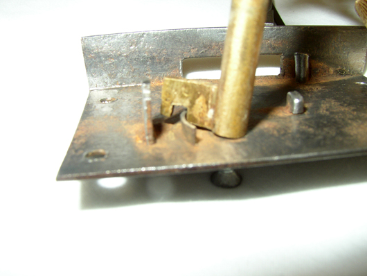 This illustration shows how a notch key works over the internal security ring of a lock plate.