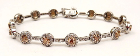 14K white gold bracelet with 15 champagne-color diamonds, each surrounded by 10 white diamonds. Total diamond weight: 5.0 carats, est. $1,000-$2,000. Stephenson’s Auction image