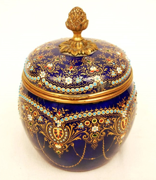 Gilt and enamel on cobalt blue French porcelain dresser box containing three perfume bottles with matching lids, est. $600-$1,000. Stephenson’s Auction image