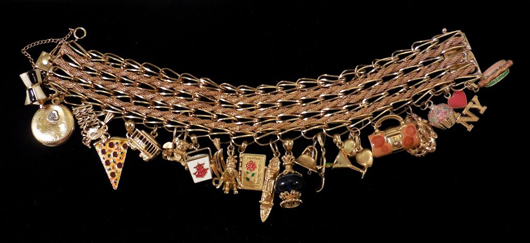 14K gold triple-strand charm bracelet with 22 gold charms, est. $2,500-$4,000. Stephenson’s Auction image
