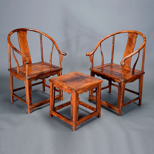 Pair of huanghuali horseshoe-back armchairs and a side table sold for $100,300. Michaan’s Auctions image.