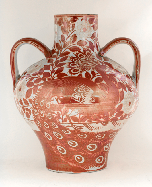 William de Morgan luster twin-handle vase, early Fulham Period, decorated each side with a peacock among flowering foliage, impressed Sand's End Pottery, crack filled, firing crack, 37cm high. Estimate: £7,000-£10,000. Sworders Fine Art Auctioneers image.
