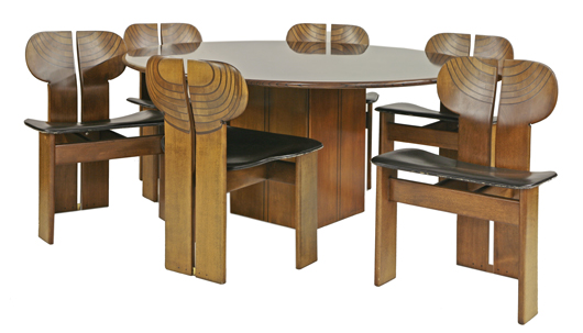 Artona dining suite, designed in 1975 for Maxalto by Afra and Tobia Scarpa, in walnut with ebonised details, table labeled 'Contrappeso Cemento Tavolo Tondo Noce, Liberty & Co., 145cm diameter x 70cm high, and a set of six 'Africa' chairs, with black leather seats. Estimate: £3,000-£5,000. Sworders Fine Art Auctioneers image.