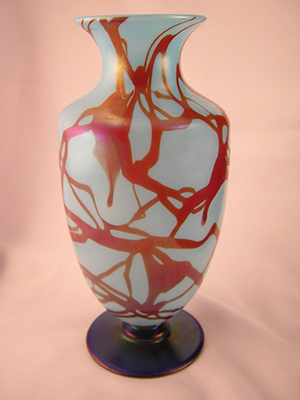 An example of rare Fenton glass, this vase is decorated in the Hanging Vine motif and has an iridized cobalt-blue foot. This particular piece, which is not part of the upcoming Fenton auction, was crafted by the group of European workers who were at Fenton in 1925-26. The vase was sold for $6,200 + buyer's premium by Randy Clark & Associates Auctioneers on Nov. 9, 2008. Image courtesy of LiveAuctioneers Archive and Randy Clark