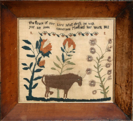 Welsh sampler stitched with a religious message above a bull amid towering foliage in original frame. It was done in 1821 by Catherine Morgan. Price: £7,500. Image courtesy of John Shepherd and Erna Hiscock.