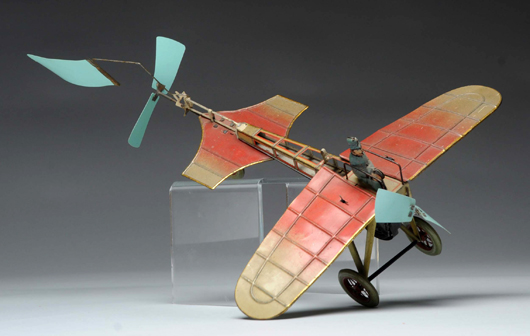 Fisher (German) tin-litho airplane with celluloid propellers and wings that flap, est. $4,000-$6,000. Morphy Auctions image