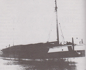 The Noquebay, shown loaded with lumber, was built in 1872 as a schooner but was eventually used as a barge. It caught fire off Stockton Island on Oct. 9, 1905. Image courtesy of Wikimedia Commons.