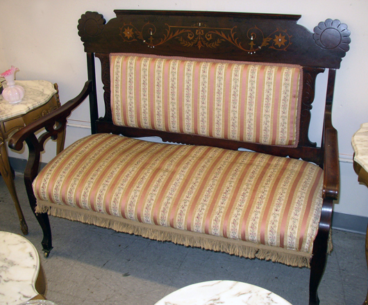 This settee from a parlor set, circa 1900, is made entirely of birch with a mahogany finish as described in the Sears catalog. A similar five-piece upholstered set was shown in the 1902 catalog for $12.45.