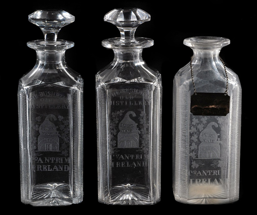 Set of three cut and engraved commemorative spirit decanters with two original stoppers, Bushmills Distillery, late 19th century. Estimate: £300-500. Dreweatts & Bloomsbury Auctions image.