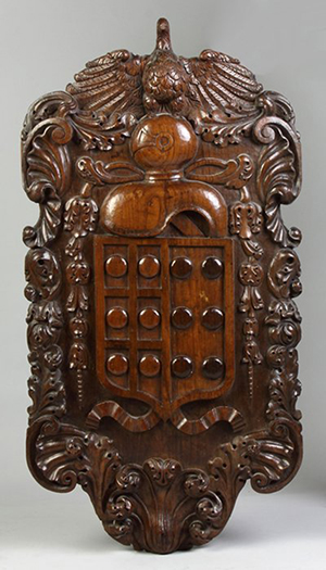 An early carved oak coat of arms panel. Image courtesy of LiveAuctioneers.com and Cottone Auctions.
