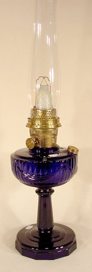 B-76 Tall Lincoln Drape cobalt crystal Aladdin lamp with complete & working model B burner and 'Aladdin' chimney. Image courtesy of LiveAuctioneers.com Archive and Tom Harris Auction Center.